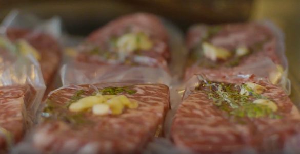 Six steaks in a sous vide bag with rosemary and garlic