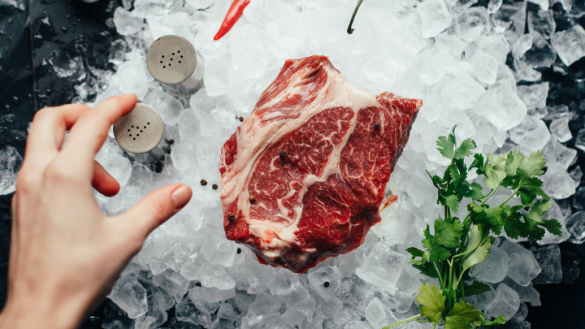 thawed steak sitting on ice cubes